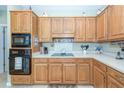 Well-equipped kitchen with ample wood cabinetry and cooktop at 340 Shyrewood Dr, Lawrenceville, GA 30043