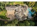 An aerial view showing the property's sprawling layout, including pool, patio, and lush greenery at 4345 Mount Paran Nw Pkwy, Atlanta, GA 30327
