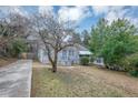 House exterior showcasing a tree and driveway at 1454 Westridge Sw Rd, Atlanta, GA 30311