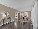 Bright living room showcasing hardwood floors, large windows, and open archways leading to other living spaces at 2144 Kennesaw Due West Nw Rd, Kennesaw, GA 30152