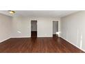 Open living area with hardwood floors and multiple access points to other rooms at 2259 Nelms Sw Dr, Atlanta, GA 30315