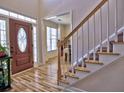 Bright entryway with hardwood floors, staircase, and wood door at 1326 Nantahala Ne Trl, Marietta, GA 30062