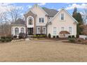 Two-story house with stone accents and a manicured lawn at 2960 Millwater Xing, Dacula, GA 30019