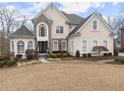 Two-story house with stone accents and a manicured lawn at 2960 Millwater Xing, Dacula, GA 30019