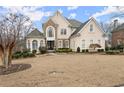 Two-story house with stone accents and a manicured lawn at 2960 Millwater Crossing, Dacula, GA 30019