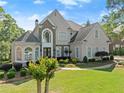 Beautiful two-story home featuring a well-manicured front lawn and inviting walkway at 2960 Millwater Xing, Dacula, GA 30019