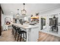 Spacious kitchen with white cabinets, island, and brick accent wall at 570 N Burnt Hickory Rd, Douglasville, GA 30134