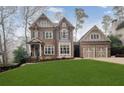 Brick house with two-car garage and manicured lawn at 2733 Caldwell Rd, Brookhaven, GA 30319