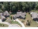 Expansive aerial view of a landscaped property featuring mature trees, a well-manicured lawn, and a swimming pool at 2182 Nillville Dr, Buford, GA 30519