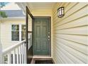 Front door entry with dark green door and white railing at 918 Cannongate Sw Xing, Marietta, GA 30064