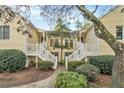 Front view of a yellow two-story building with white stairs and landscaping at 918 Cannongate Sw Xing, Marietta, GA 30064