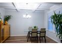 Bright dining room featuring a modern chandelier, hardwood floors, and large window at 3004 Amabile Rd, Dacula, GA 30019
