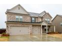 Attractive two-story home with a brick facade, a two-car garage, and a well-manicured lawn at 3004 Amabile Rd, Dacula, GA 30019