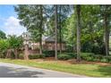 Brick home nestled among lush trees and landscaping at 1446 W Wesley Nw Rd, Atlanta, GA 30327