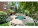 Inviting kidney-shaped pool with a large patio at 1446 W Wesley Nw Rd, Atlanta, GA 30327