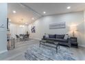 Bright living room with vaulted ceilings, grey sofa, and a circular rug at 2125 Jessica Way, Lithonia, GA 30058