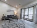 Spacious living room featuring bay windows, grey sofa, and hardwood floors at 2125 Jessica Way, Lithonia, GA 30058