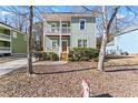 Two-story light green house with a front porch and driveway at 283 Boulder Park Ln, Atlanta, GA 30331