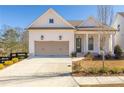 White two-story home with a neutral colored garage door and covered porch at 210 Idylwilde Way, Canton, GA 30115