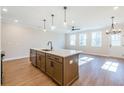 Open concept kitchen with island and hardwood floors at 147 Bluffington Way, Marietta, GA 30066