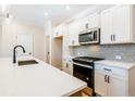 Modern kitchen features white cabinets, stainless steel appliances, and quartz countertops at 147 Bluffington Way, Marietta, GA 30066