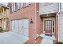 Front entry of townhome with brick facade and double doors at 5760 Vista Brook Dr, Suwanee, GA 30024