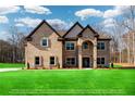 Beautiful two-story brick home boasting a lush lawn and a classic architectural design at 2571 Se Ebenezer Rd, Conyers, GA 30094