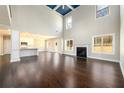 Bright, open living area with soaring ceilings, fireplace, hardwood floors, and seamless flow to the kitchen at 2571 Se Ebenezer Rd, Conyers, GA 30094