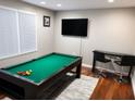 Entertainment room equipped with a pool table, bar seating, and a wall-mounted TV for recreation at 2290 Wilkins Cv, Decatur, GA 30035