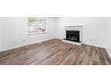 Bright living room featuring a fireplace and wood-look floors at 2290 Wilkins Cv, Decatur, GA 30035