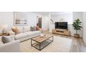 Bright living room featuring a plush sofa, modern furniture, and stylish decor for comfortable living at 2290 Wilkins Cv, Decatur, GA 30035