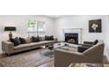 Elegant living area with a fireplace, modern sofa, and stylish decor for comfortable gatherings at 2290 Wilkins Cv, Decatur, GA 30035
