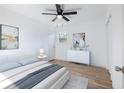 Bright bedroom with a queen-size bed, a dresser, and hardwood floors at 488 Village Run, Lawrenceville, GA 30046