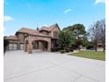 Elegant brick home showing porte-cochere, attached two-car garage and long paved driveway at 1255 Mcminn Way, Snellville, GA 30078