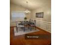 Dining area with modern chandelier, table setting, and light-filled window view at 1060 S Creek Dr, Villa Rica, GA 30180