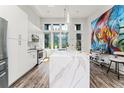 Modern kitchen with white cabinets and a large quartz waterfall island at 462 Latta Ne St, Atlanta, GA 30308