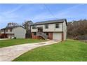 Two-story house with brick and siding, a grassy yard, and a driveway at 2729 Oxford Dr, Decatur, GA 30034