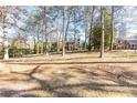 Spacious backyard with mature trees and a flat grassy area at 2933 Andrews Nw Dr, Atlanta, GA 30305