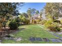 Landscaped backyard with a large lawn and stone pathways at 2933 Andrews Nw Dr, Atlanta, GA 30305