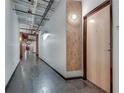 Clean and well-lit hallway with exposed pipes and modern wall decor at 878 Peachtree Ne St # 535, Atlanta, GA 30309