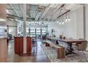 Spacious living area with an open layout, exposed ductwork, and a stylish dining table illuminated by modern pendant lights at 878 Peachtree Ne St # 535, Atlanta, GA 30309