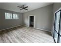 Bright bedroom features a ceiling fan, wood floors, and access to the outdoor deck at 5145 Dublin Sw Dr, Atlanta, GA 30331