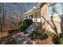 Charming stone entrance with stone steps and manicured bushes at 4286 Pool Rd, Winston, GA 30187