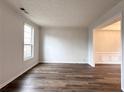 Bright living room with wood-look floors and ample natural light from a large window at 1999 Riverlanding Cir, Lawrenceville, GA 30046