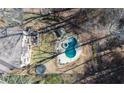 Aerial view of house, pool, and backyard with trampoline and batting cage at 925 Upper Hembree Rd, Roswell, GA 30076