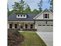 Charming home showcasing a well-manicured lawn and a classic architectural style with a two-car garage at 6093 Wayfarer Dr, Villa Rica, GA 30180