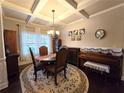 Elegant dining room features hardwood floors and a coffered ceiling at 965 Mulberry Bay Dr, Dacula, GA 30019