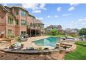 Stunning backyard with a large pool, spa, and patio perfect for outdoor entertaining at 3215 Kylee Dawn Cir, Lawrenceville, GA 30045