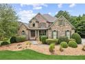 Charming home exterior boasts stone accents, mature landscaping, and a welcoming front porch at 3215 Kylee Dawn Cir, Lawrenceville, GA 30045