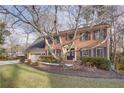 Two-story brick home with mature trees and landscaping at 3736 Bloxham Ct, Atlanta, GA 30341